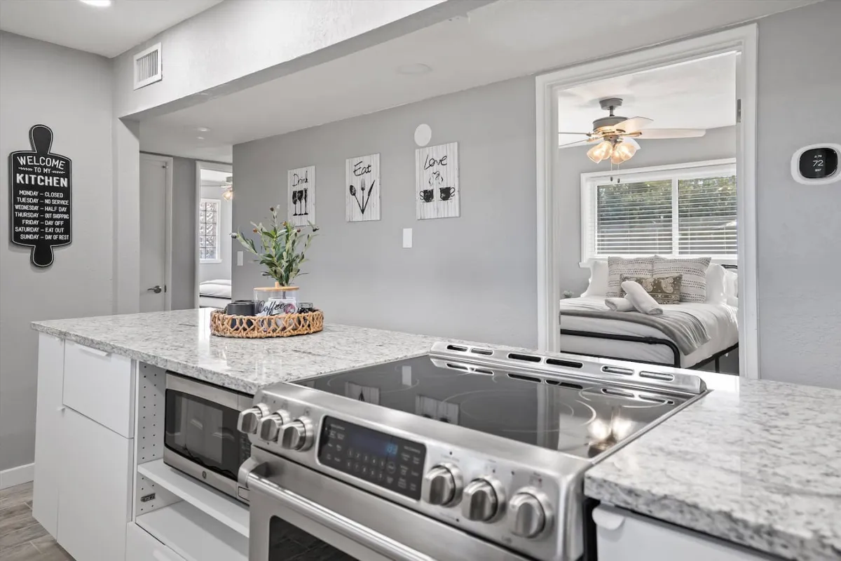 A modern kitchen island with a sleek stove, ample counter space, decorative wall art, and plenty of room for meal preparations or casual dining. The design is both functional and stylish, emphasizing the kitchen’s role as a hub for daily routines and gatherings.